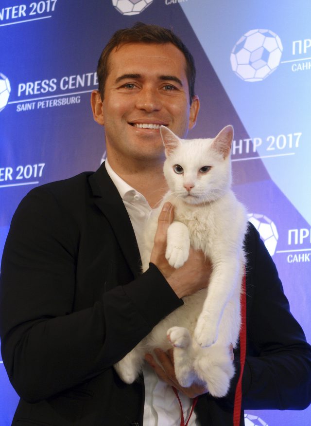 Russian footballer Aleksandr Kerzhakov poses with Achilles the cat