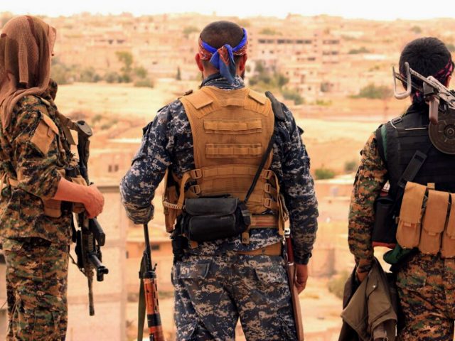 Syrian Democratic Forces fighters look towards the northern town of Tabqa (Syrian Democratic Forces via AP)