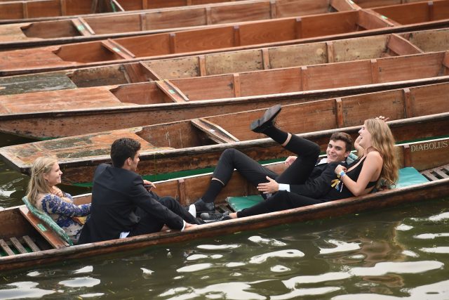 Students enjoy a punt ride along the river Cam after attending a May Ball at Cambridge University 