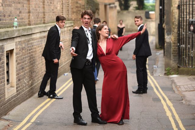 Students from Cambridge University make their way home after celebrating the end of the academic year 