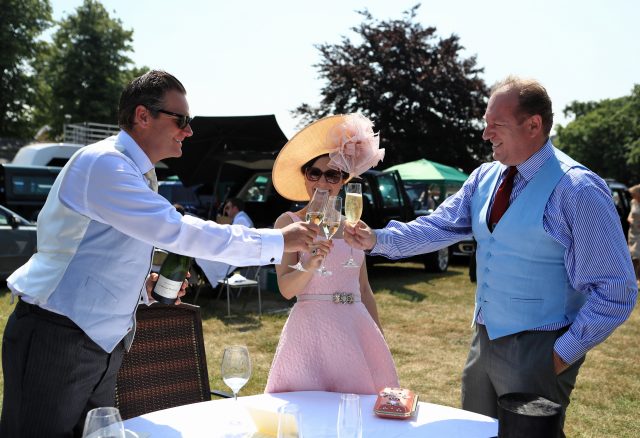 Racegoers enjoy a glass champagne during day one of Royal Ascot 
