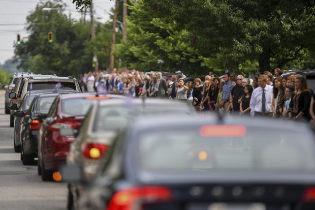 Mourners line the street after the funeral of Otto Warmbier (Bryan Woolston/AP)
