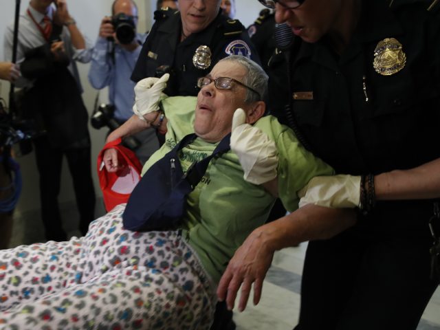 A protester is removed from the office of Senate majority leader Mitch McConnell (Jacquelyn Martin/AP)