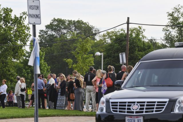 Mourners line up as they arrive for the funeral of Otto Warmbier