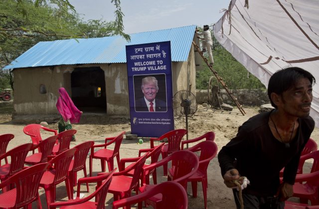 Indian workers set up a tent for the inauguration of Trump Sulabh Village 