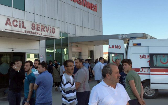 People wait outside a hospital after five people were caught up in an electrical current in the pool at the park in the town of Akyazi (IHA via AP)