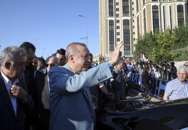 Turkey's President Recep Tayyip Erdogan waves toward his supporters after the Eid al-Fitr prayers in Istanbul (Presidential Press Service/AP)