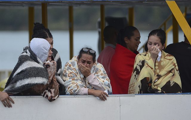 People who survived a sunken ferry, cry as they wait for more information about their missing friends and relatives (Luis Benavides/AP)