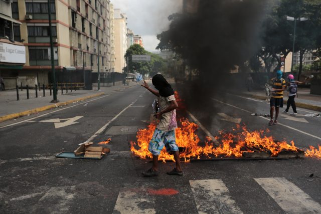 A burning barricade was set up by anti-government protesters (AP) 