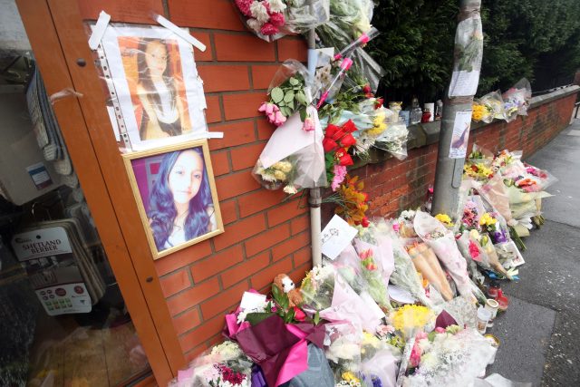 Floral tributes at the scene of the hit and run crash which claimed the lives of Helina Kotlarova, 12 and Zaneta Krokova, 11, following their funeral (Danny Lawson/PA)