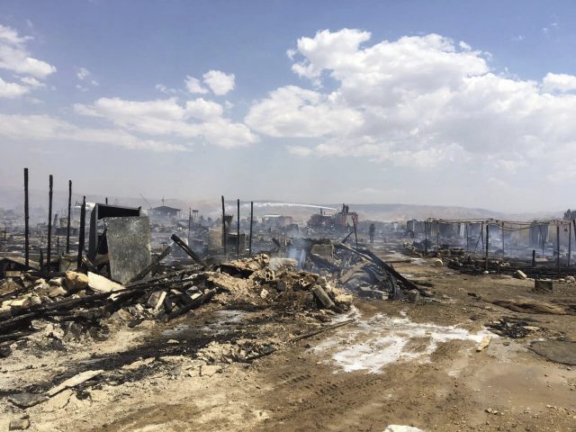 Lebanese Civil Defence workers putting out a fire in a Syrian refugee camp in Qab Elias (Qab Elias Emergency Services via AP)
