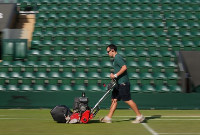 A groundsman with a roller on Wimbledon's court 3