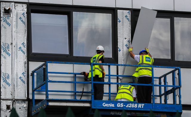 Cladding being removed from a housing building in Manchester (PA)