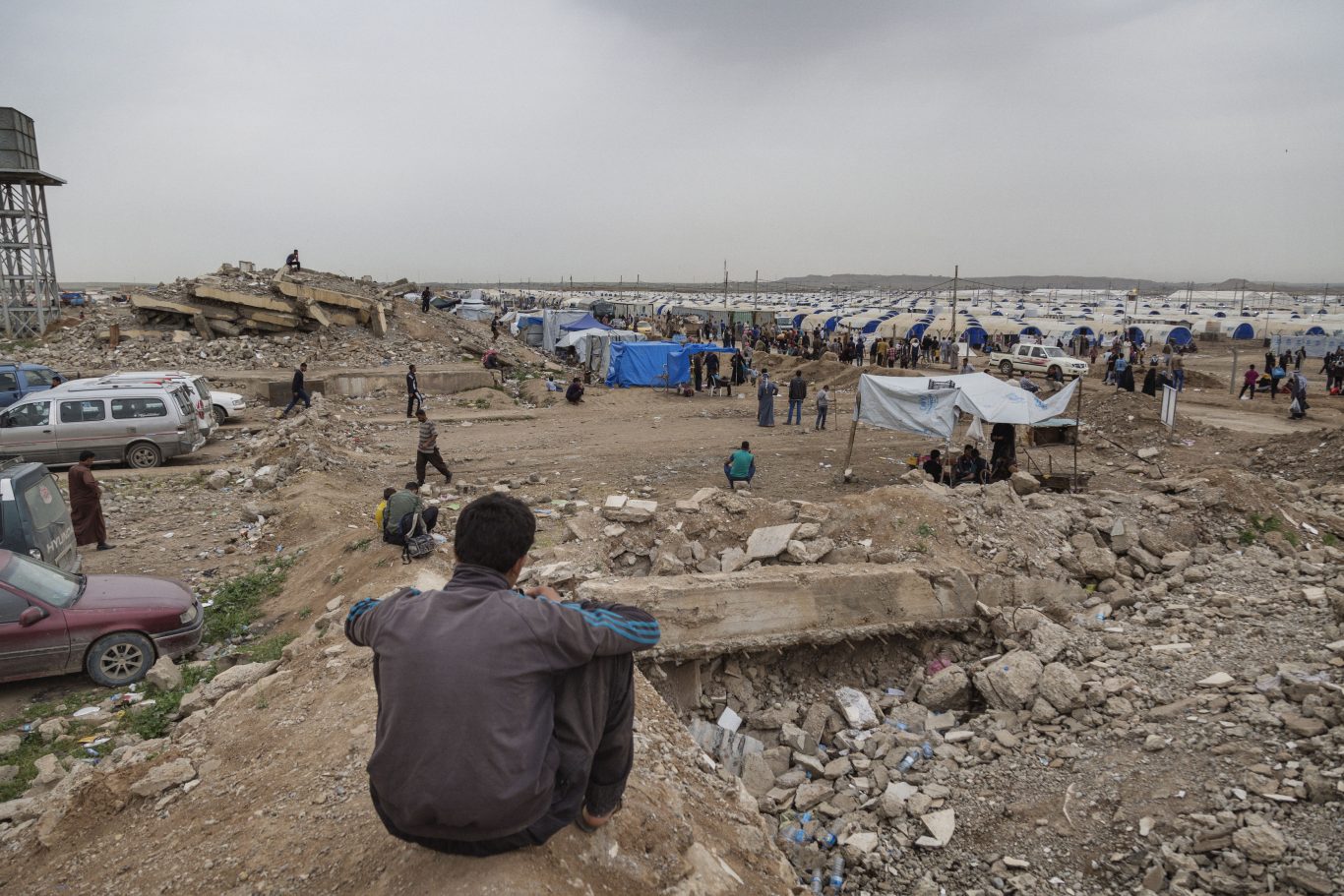 A boy looking at the Hammam al Alil IDP camp from the top of the ruins of what used to be the Agricultural University of Hammam al Alil, in Iraq (Save the Children)