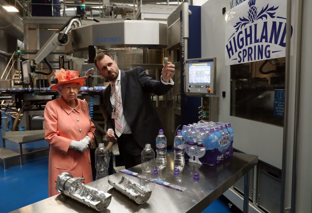 The Queen is shown the bottle making and filling process. (Andrew Milligan/PA)
