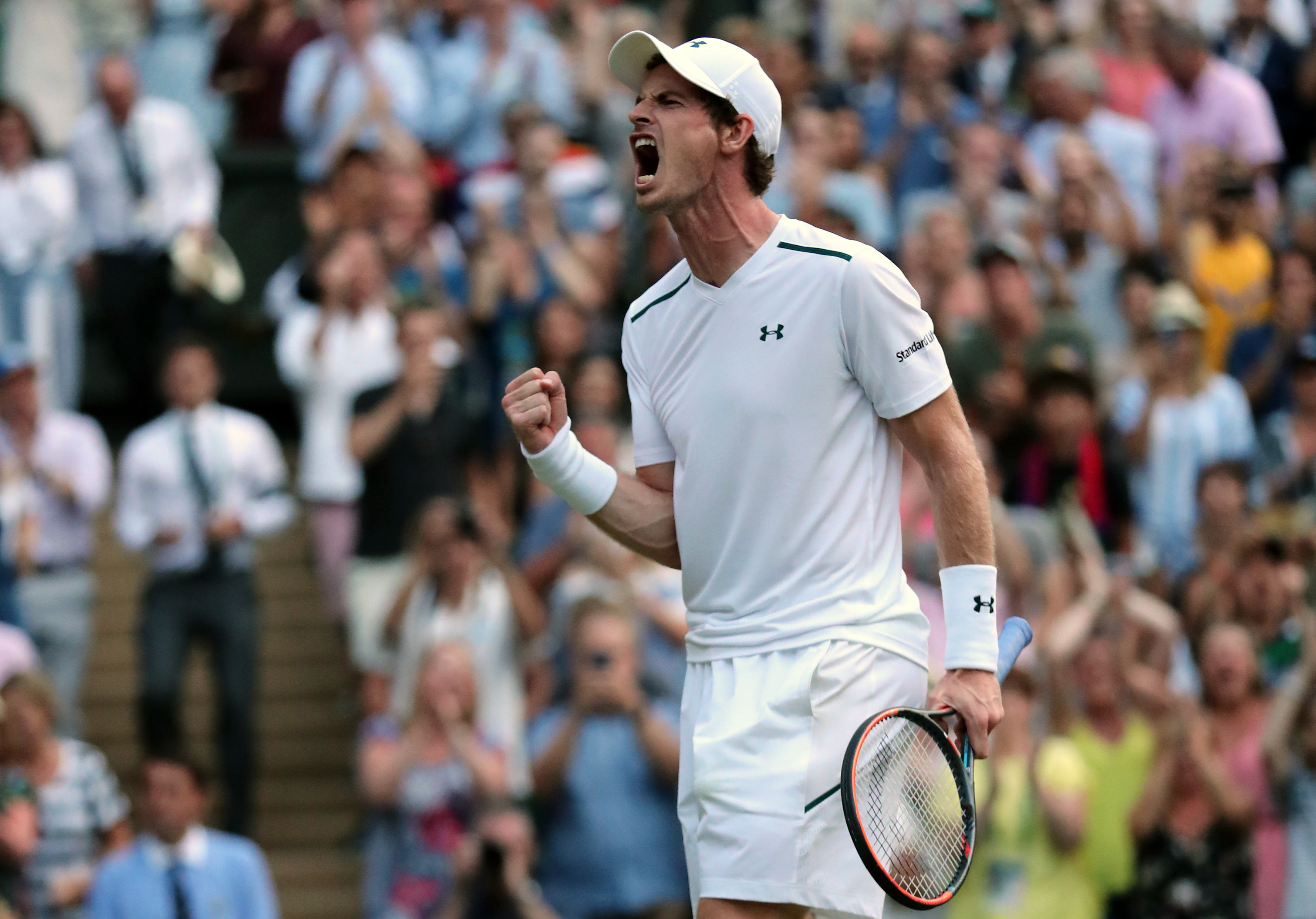 Andy Murray celebrates victory over Fabio Fognini on day five of the Wimbledon Championships at The All England Lawn Tennis and Croquet Club, Wimbledon.