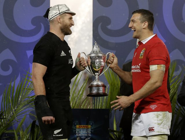 Rival captains Kieran Read, left, and Sam Warburton joke as they hold the trophy 