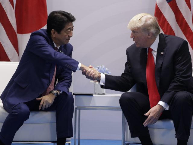 Japan's Shinzo Abe greets Donald Trump (Evan Vucci/AP)