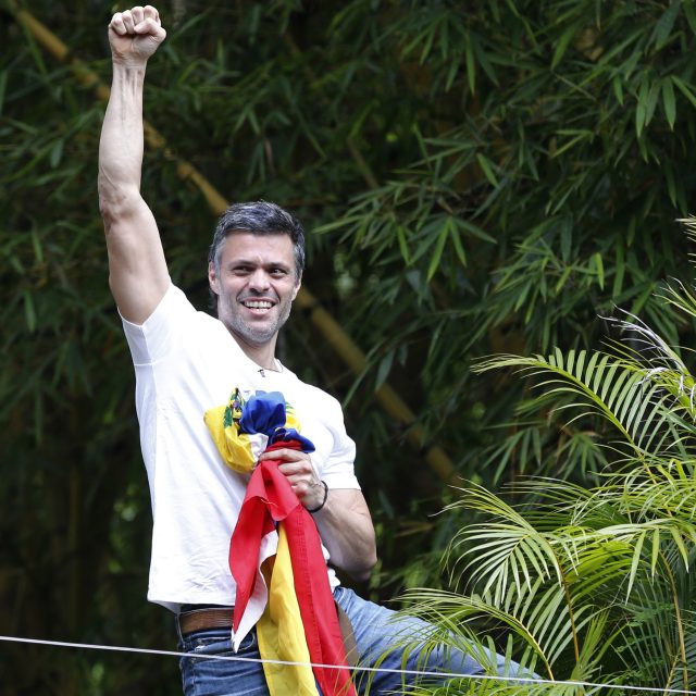 Leopoldo Lopez salutes supporters outside his home (Ariana Cubillos/AP)