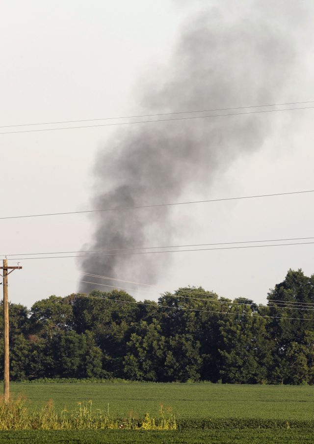 Smoke rises in the air after the military transport plane crashed (Andy Lo/AP)