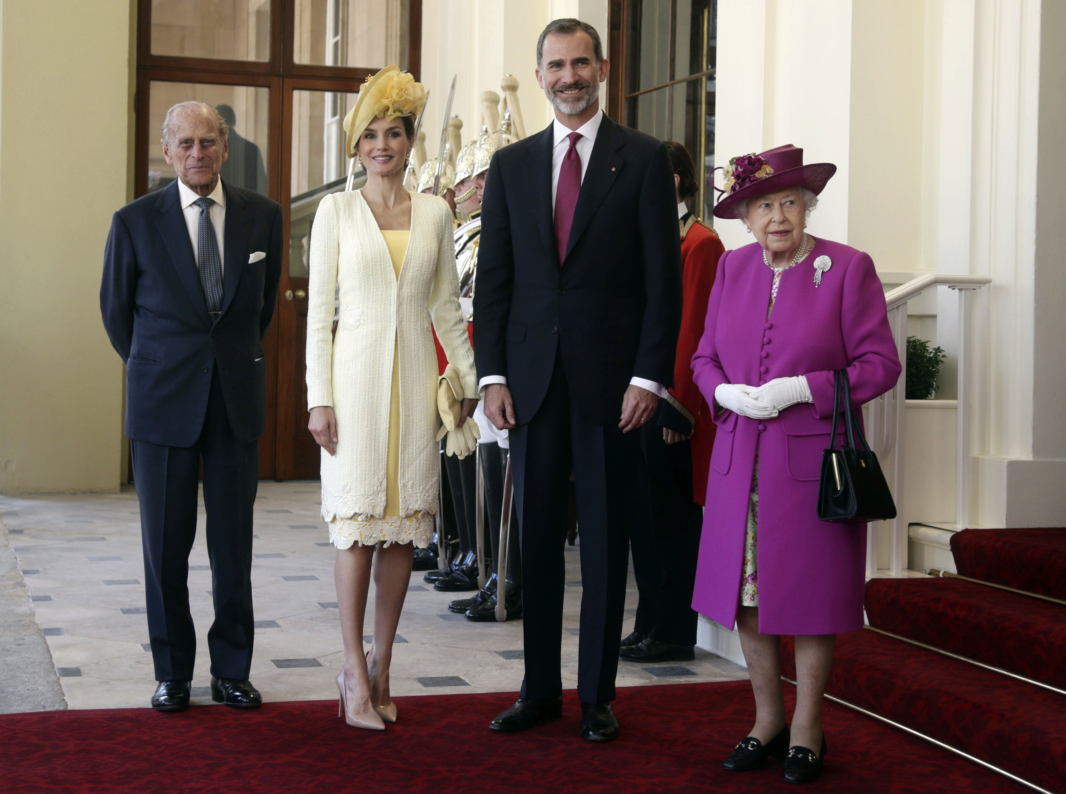 Britain's Queen Elizabeth II stands with Spain's King Felipe and his wife Queen Letizia and Prince Philip, left, after arriving in a state carriage to Buckingham Palace, London 