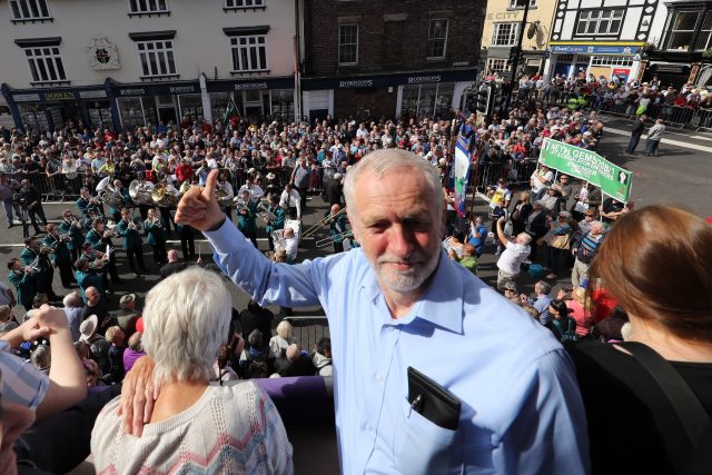 Labour leader Jeremy Corbyn watches the parade from the balcony of the Royal County Hotel during the Durham Miners' Gala in Durham.