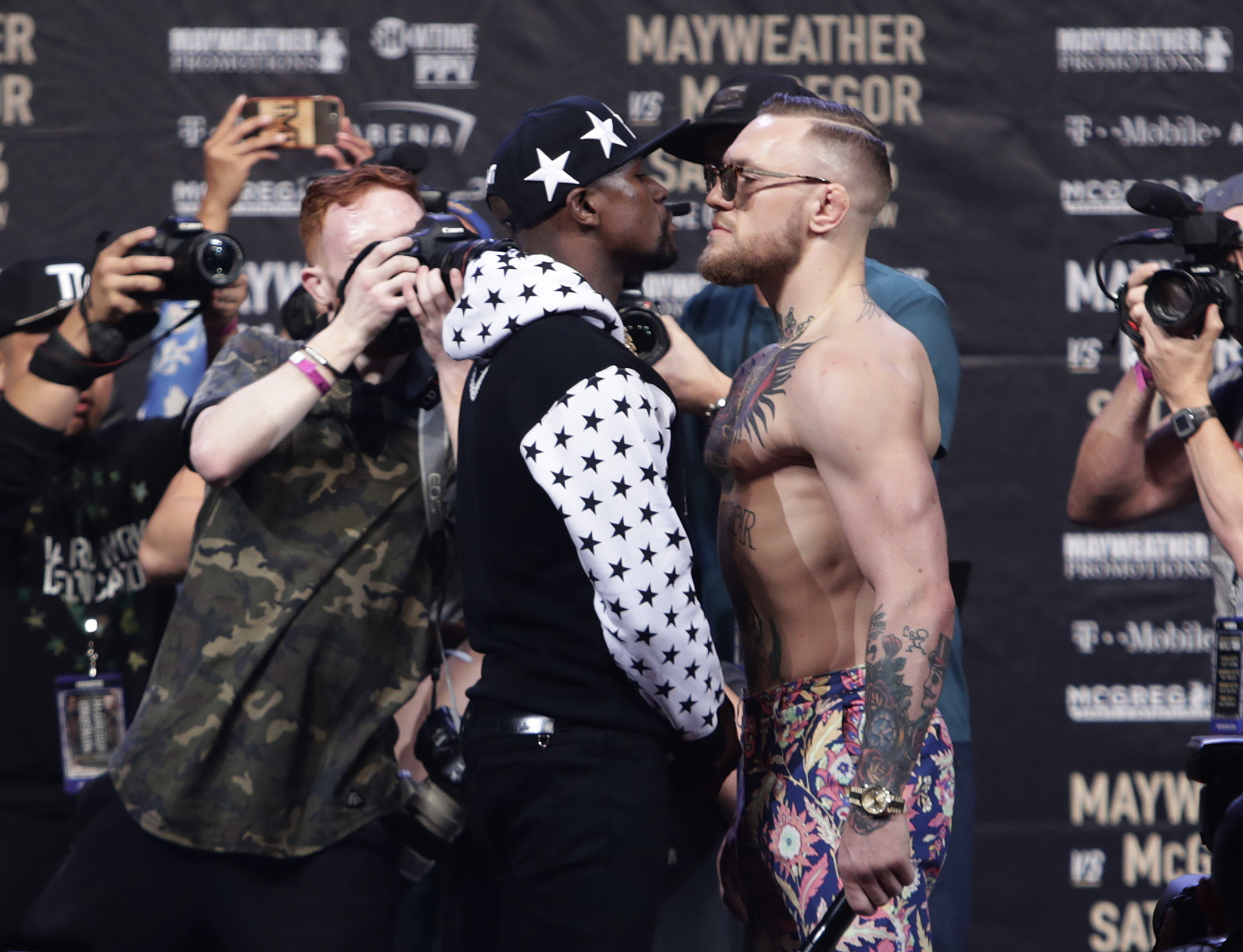 Floyd Mayweather Jr., left, and Conor McGregor exchange words during a news conference at Barclays Center on Thursday, July 13, 2017, in New York. (AP Photo/Frank Franklin II)