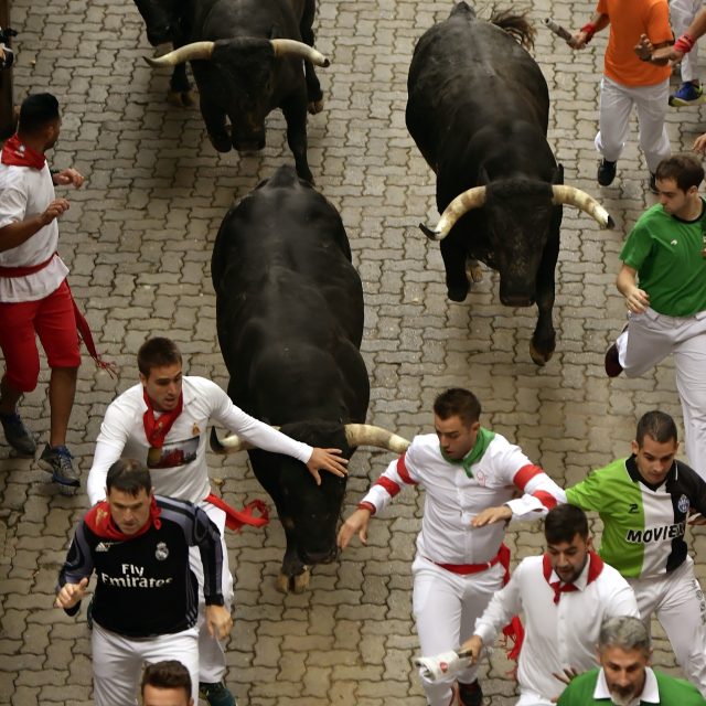 The bulls give chase in Pamplona (Alvaro Barrientos/AP)