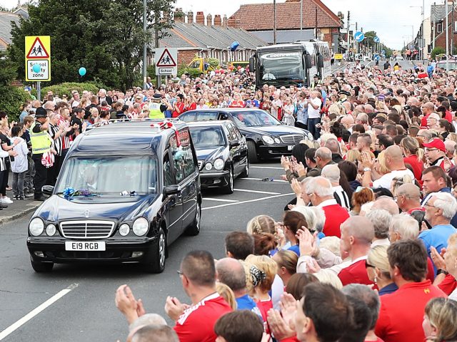 Crowds applauded as the cortege arrived (Owen Humphreys/PA)