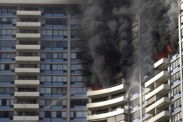 Fire could be seen on several balconies at the Marco Polo apartment complex (Marco Garcia/AP)
