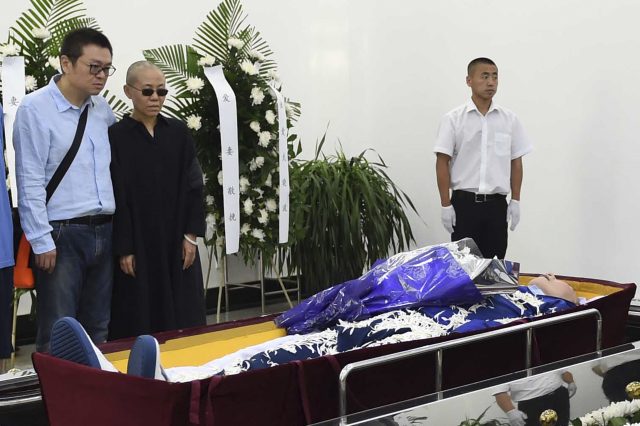 Liu Xia, who has been under house arrest, was pictured at her husband's funeral in Shenyang (Shenyang Municipal Information Office/AP)