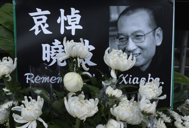 Tributes to Mr Liu were placed outside the Chinese liaison office in Hong Kong (Vincent Yu/AP)