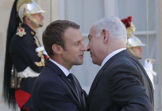 President Emmanuel Macron welcomes Israeli Prime Minister Benjamin Netanyahu. (Michel Euler/AP)