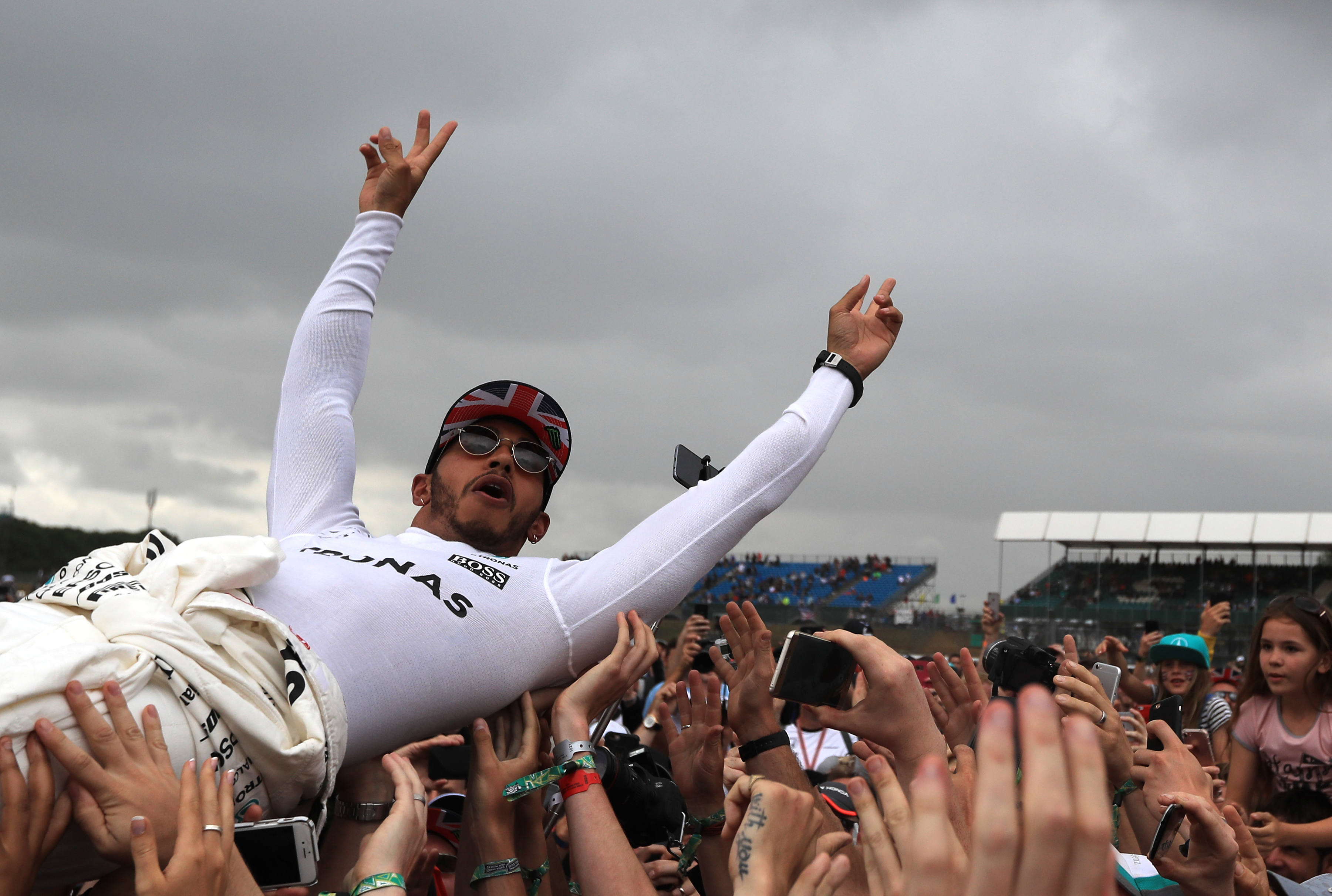 Mercedes' Lewis Hamilton celebrates by crowdsurfing with fans after winning the 2017 British Grand Prix at Silverstone Circuit, Towcester.