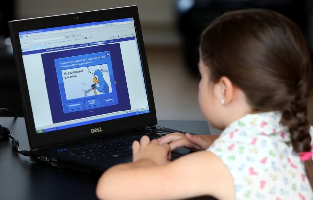 A child surfs the internet on a laptop