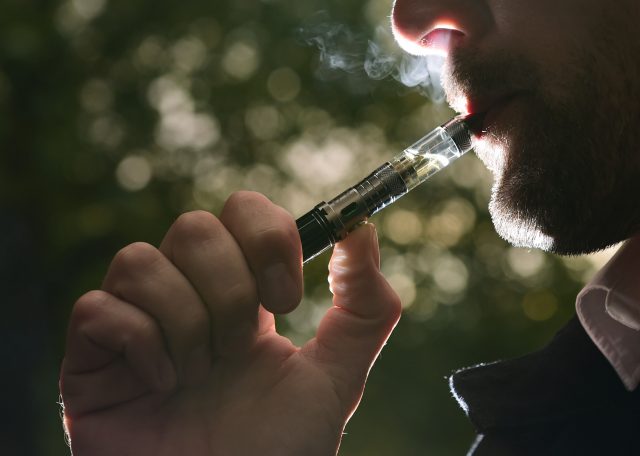 A man smoking an electronic cigarette