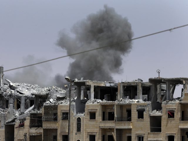 The aftermath of a coalition air strike in Raqqa (Hussein Malla/AP)
