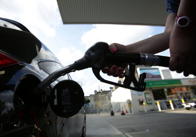 A car being filled up with a pump at a petrol station