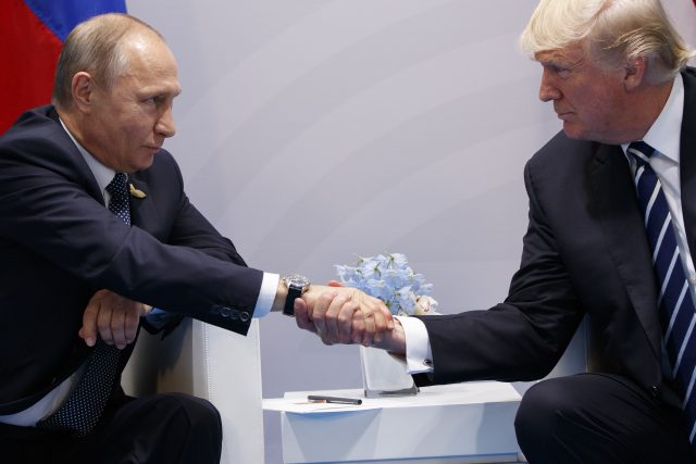 US President Donald Trump shakes hands with Russian President Vladimir Putin