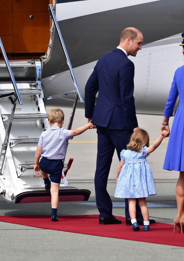 Prince George tugs at William's hand