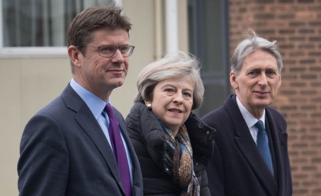 Prime Minister Theresa May walks with Business Secretary Greg Clark and Chancellor of the Exchequer Philip Hammond