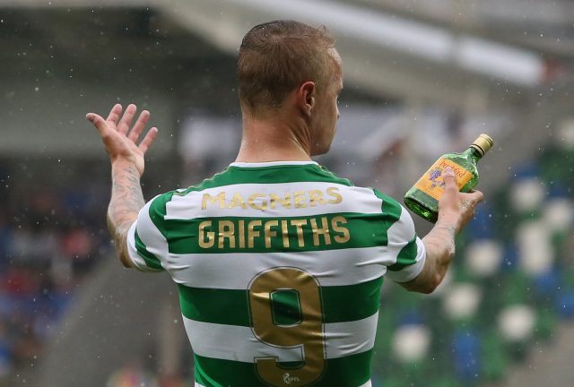 Leigh Griffiths holds a glass bottle thrown at him from the stands at Windsor Park (Niall Carson/PA)