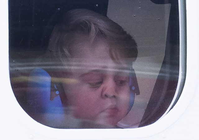 Prince George squashes his nose against the window of a seaplane