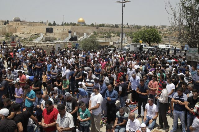 Palestinians pray outside Jerusalem's Old City