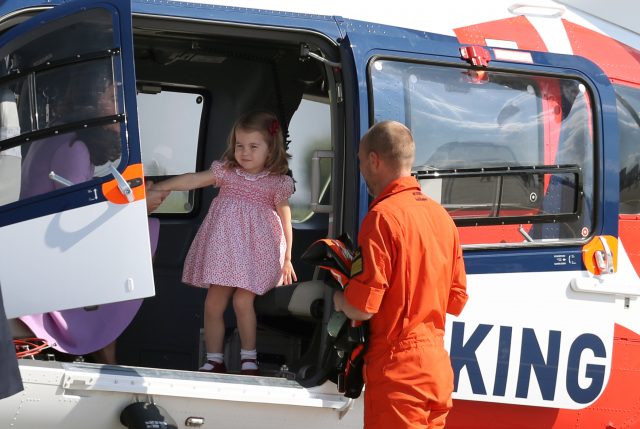 Princess Charlotte looks around the rescue helicopter with the Duchess of Cambridge