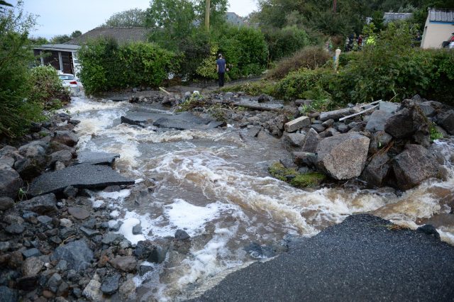 A driveway is lifted caused by water from flash flooding in the coastal village of Coverack (Ben Birchall/PA)