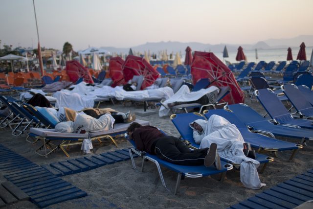 Tourists sleep on sunbeds