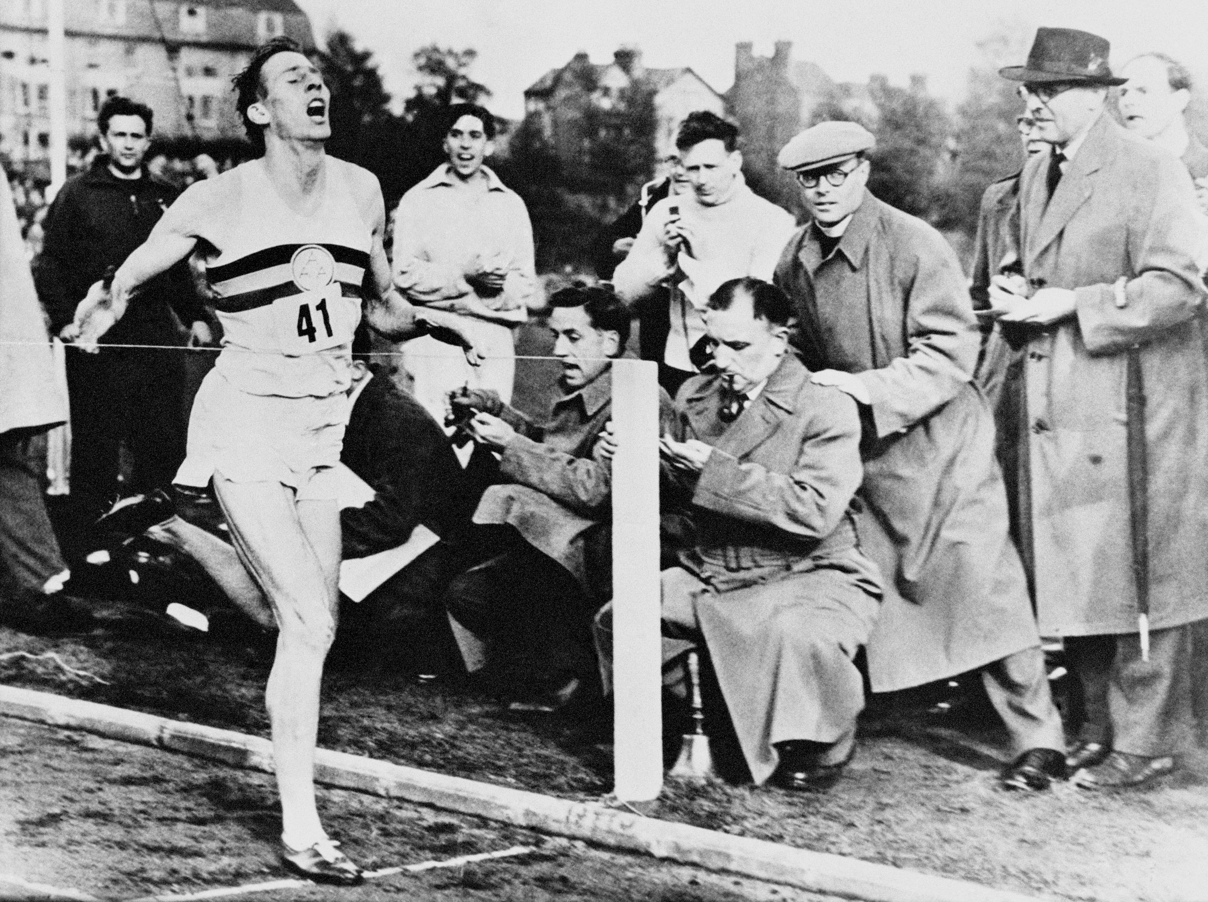 Roger Bannister completes a sub four-minute mile