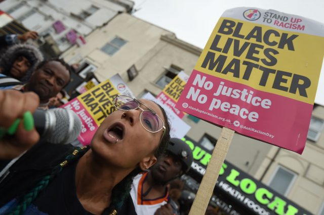 Up to 150 people, many holding Black Lives Matter banners, brought traffic to a standstill 