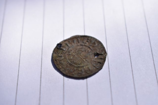 A 1,100-year-old Anglo Saxon coin found at their archaeological dig at Burghead Fort 